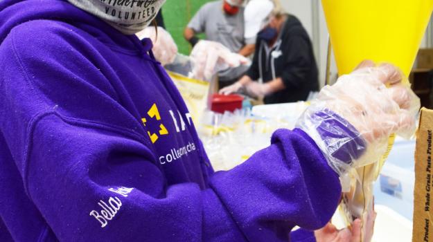 Bella, a student at BART, packs meal bags at an April 17 volunteer event