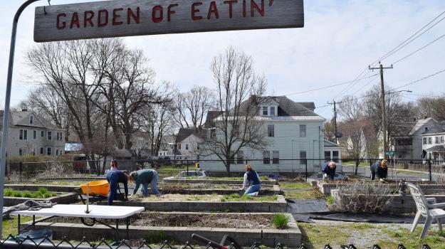 Volunteers clean up the garden at Rice Silk Mill